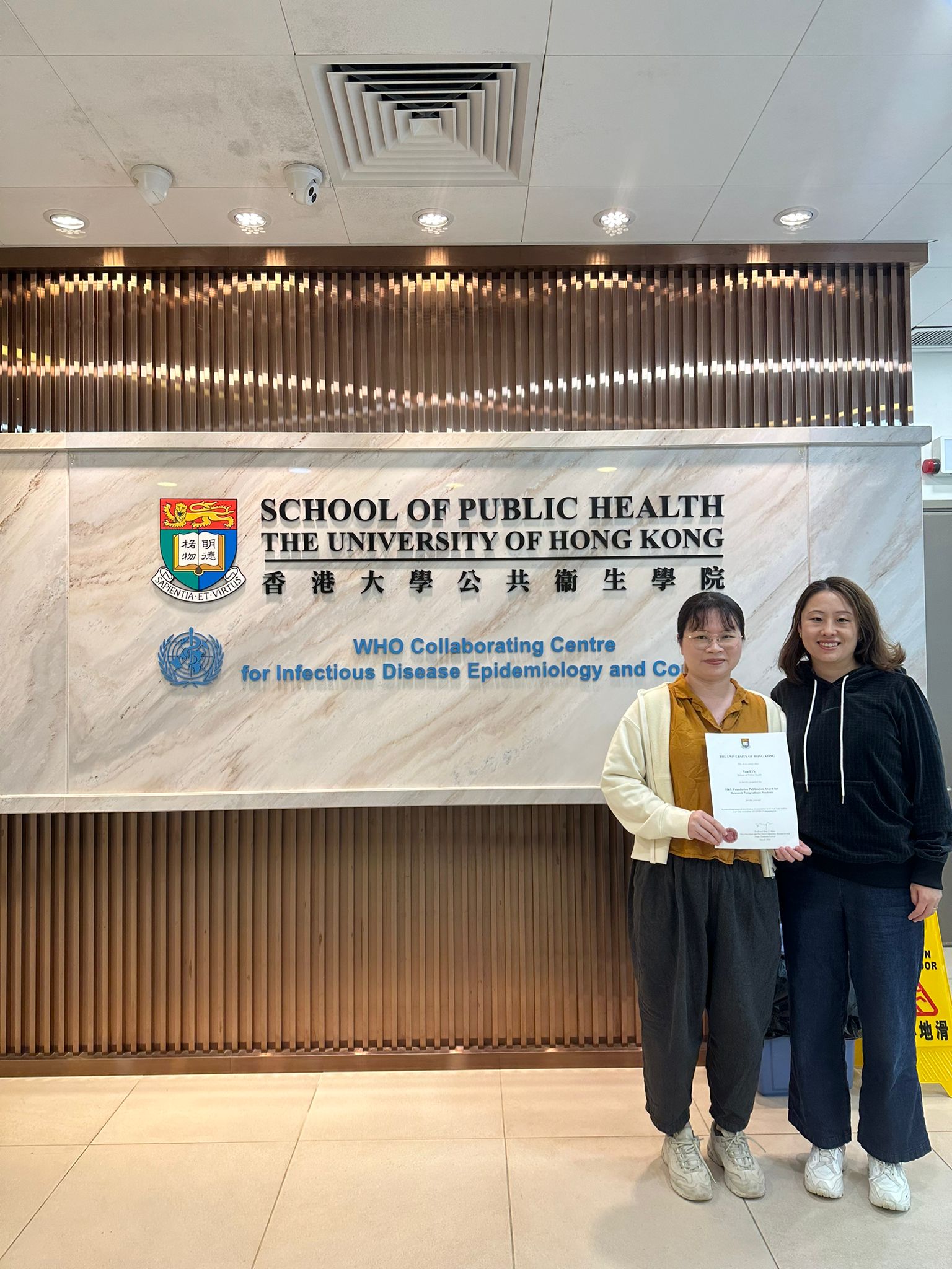 Ms Yun Lin (left) thanks her co-first author, Dr Bingyi Yang