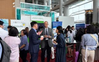 Professor David Bishai and Professor Wendy Lam Wing-tak interact with a guest.