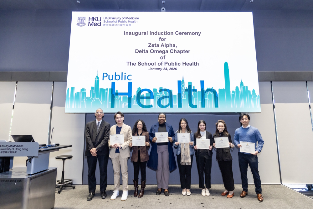 Professor David Bishai presents certificates to the inductees at the Inaugural Induction Ceremony for the Zeta Alpha, Delta Omega Chapter of the School of Public Health.